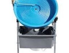 Pro Camel 24" Automatic Spiral Wheel Gold Panning Machine - Variable Speed Product Information: Our largest spiral wheel, the Pro Camel 24" spiral wheel gold panning machine is designed to capture more gold quicker. With the large wheel, you can process more gold than a smaller spiral wheel faster. Pro-Camel Automatic Gold Panning Machines Pro Camel 24" Automatic Spiral Wheel Gold Panning Machine - Variable Speed If you’ve ever had to pan buckets and buckets of concentrates by hand, you know how much work it is, how much time it takes, and especially how much your legs and back ache when you’re done. What you don’t realize, is how much gold you’re loosing! Even a seasoned gold panner is going to miss some gold when panning by hand, especially if the concentrates are heavy with black sand. So for the beginner or average panner, the odds of washing some of the gold out of the pan are even higher. Let’s face it, loosing some gold while panning by hand is simply a fact of panning and something we should expect. This is why Automatic Spiral Gold Panning Machines are so popular today. They ease the burden of panning by hand by doing all of the hard work for you and doing it the same way over and over again. They allow you to process significantly more material in much less time. They increase your gold recovery effectiveness by a factor of 50. That means you will recover 50 times more gold than you would working by hand with a traditional gold pan. The first Automatic Spiral Gold Panning Machine was introduced to the public over 40 years ago, back in 1969, by the pioneer and inventor of the Spiral Panning Machine, Angus Niccolls, who also founded Camel Mining Products, Inc. This first machine was called the Little Camel and was an instant hit with the small mining community. It was small, light weight, portable, used a 12 volt battery for power, and only needed three gallons of water to operate. Over time, the design was improved and it grew into what is known today as the Desert Fox Automatic Gold Panning Machine which is the #1 selling Automatic Spiral Gold Panning Machine on the market. Though the Desert Fox Automatic Gold Panning Machine does a great job recovering gold, it is limited to the amount of material it can process (about 70 pounds of concentrates an hour). This limitation, along with a cry from the mining community for something bigger, gave way to a new Automatic Spiral Gold Panning Machine called the Pro-Camel Automatic Gold Panning Machine. This new machine, though much bigger than the Desert Fox, still effectively operates using a 12 volt battery, but can process an incredible 400 pounds of placer sand an hour using the 24″ wheel. That’s a 471% increase in processing power and with a newly designed 2-stage spiral wheel, the gold recovery is even better. The Pro-Camel Automatic Gold Panning Machine is available with two different wheel sizes (18″ & 24″). Everything else about the machine is the same, so you can use the different wheels on the same drive unit. History of the Pro-Camel The Pro-Camel 24 Automatic Gold Panning Machine (24″ Spiral Wheel) is the big brother of the Desert Fox Automatic Gold Panning Machine and the largest 12-volt automatic spiral gold panning machine manufactured anywhere. It was introduced to the mining community in 2009 and has received rave reviews since its release and is known as one of the top fine gold recovery systems on the market today. In 2011, the Pro-Camel 18 Automatic Gold Panning Machine (18″ Spiral Wheel) was released to the public. It is essentially the same machine as the Pro-Camel 24 with a different size wheel. Features of the Pro-Camel Automatic Gold Panning Machine Created by Camel Mining Products, Inc. the pioneers in spiral panning technology for more than 40 years. It is a fast, high capacity machine capable of processing up to 400 pounds of placer sand per hour. That is a 471% increase in processing capacity over the Desert Fox Automatic Gold Panning Machine. Unique 2-stage Spiral Wheel 15 Spiral riffles lead into an inset second stage of 5 additional spiral riffles. This innovative design increases gold recovery over the standard single stage wheels. Exclusive Aqua-Jet technology ensures that the material stays in a slurry allowing the gold to drop out into the spirals. Variable speed wheel control & adjustable water flow. Allows you to fine tune the Pro-Camel Automatic Gold Panning Machine to the material being processed. The drive unit is gear driven and uses sealed ball bearings allowing it to run smoothly, quietly, and be energy efficient. Powered by any 12-volt Battery with at least 16 amps of output. Why Does The Pro-Camel Automatic Gold Panning Machine Work So Well? The Pro-Camel Automatic Gold Panning Machine uses the same basic technology of gold separation as a traditional gold pan: Water, Motion, & Gravity. Because gold is so much heavier than the other material that it’s found with, it can be easily separated from like sized material. With a traditional gold pan, you create a slurry of water and material mixing it well to allow the gold to drop down to the bottom of the pan. You then slowly & carefully wash off the lighter material by dipping the edge of the pan in the water. The same basic principles are being applied with the Pro-Camel, but much faster and more efficiently than panning by hand. PC-Running1024-768x514.jpg The Pro-Camel’s Aqua-Jet provides an ample water supply to the edge and bottom of the spiral wheel to create the slurry needed to allow the gold to separate from the other material. As it does, the gold is scooped up in the 15 spiral riffles and stays there because of the deep “V” design. As the wheel turns, the spray bar rinses the lighter material away allowing the gold to ride up the spirals. When the gold drops into the second stage, any material tagging along for the ride is washed away allowing the clean gold to be deposited through the center hole of the wheel and into the gold catch cup hanging on the back of the machine. You might be thinking to yourself, that this is all well and good for pickers and small flake gold, but what about the fines? Can the Pro-Camel get the fine gold too? Well, the answer is a resounding YES! When the base material is properly classified, meaning the relative size of the material being processed is the same, the Pro-Camel Automatic Gold Panning Machine is hard to beat for recovering fine gold.