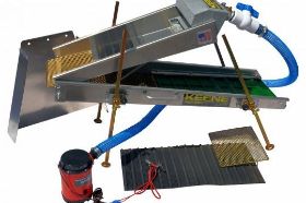Keene - MiniMax Power Sluice Concentrator MiniMax Power Sluice Concentrator - MMPSCK The new and improved Mini Max Power Sluice Concentrator is the multi-tool of prospecting. We have changed our updated machine from a double pump system to one single, larger pump. The new pump provides not only greater water flow and higher head lift but also a larger diameter pressure hose which creates a higher flow than the double pump system. We've also doubled the hose length to 8 feet, added a new ball valve for precise flow control and a screw on connector that requires no tools. Whether you are working river banks, desert placer's or just cleaning concentrates for larger dredges and equipment, the Mini Max is a prospecting tool that will always be part of your arsenal. This multi purpose package includes a removable mat for the lower sluice box, converting it to a professional clean up machine simply by sliding out the green rubber riffle and replacing it with Miracle Matting. It is also supplied with an additional finer woven mesh screen on the top hopper for using it as a concentrating system. Another new improvement is that the Mini Max is powered by a single 2200 GPH, 12 volt pump made proudly in the U.S.A. The top hopper is equipped with a flood header that provides smooth water flow through the trough, over a slick plate and in to a 6 inch section of miracle mat that gives you a preview to any captured gold! The top sluice lifts off easily so you can inspect the lower sluice, eliminating the need for cleaning. The material is then washed over a removable classifier grizzly screen, removing the oversized waste gravel. The bottom sluice box is lined with our green rubber riffle that recovers ultra fine gold and can handle larger volumes of material. When used as a concentrating system, the lower sluice is partially covered by oversized expanded metal. When used as a power sluice you can expect a capacity of up to a quarter of a yard per hour and about a third of its capacity when used as a concentrating machine. This Mini Max can also be operated by a small, single gas powered pump such as our P90G Pump Kit. This device is ideal for backpacking given it folds up into an compact size of 36 by 14 by 7 inches and weighs under 23 pounds. The four independent legs fold up with our new pin-lock folding system with large wing nuts that make it a breeze to adjust elevation and articulation. The Mini Max also includes a mountable flare for use as a hand sluice. Net weight 23 pounds. Shipping weight 29 lbs.